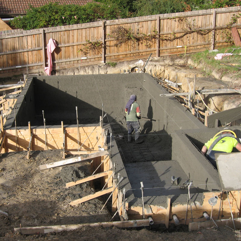 Construction workers building a swimming pool